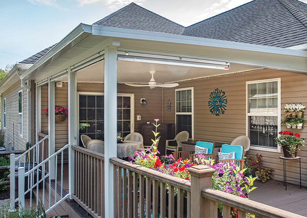 Scenic patio cover adorned with blooming flora and complemented by comfortable outdoor seating