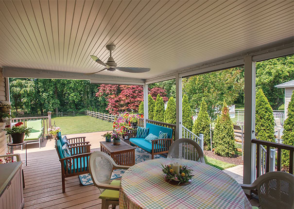 A charming enclosed patio w, adorned with tastefully furnished seating areas in a delightful shade of blue