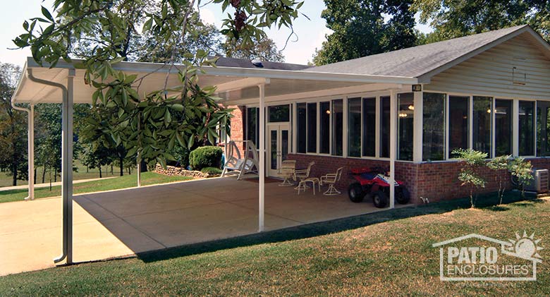 White patio cover provides protection for large gatherings and doubles as a car port